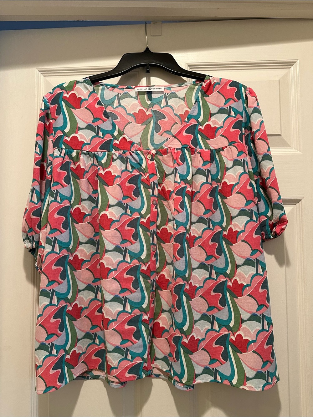 Fresh eye-catching fabric in a V-Neck Blouse highlighting Pinks & Teals!